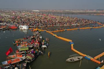 Golden Triangle Tour with Prayagraj featuring the Triveni Sangam, sacred river confluence, and pilgrims during a spiritual journey in India.